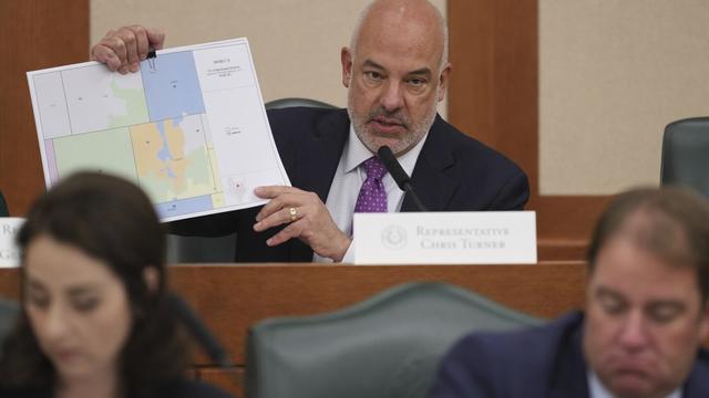 Texas state Rep Chris Turner holds a map as he asks questions during a public hearing on congressional redistricting in Austin, Texas, Friday, Aug. 1, 2025. (AP Photo/Eric Gay)