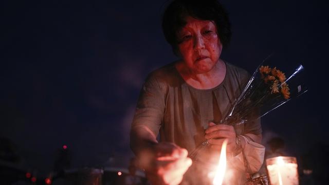 A visitor lights incense sticks at the Peace Memorial Park ahead of the memorial service to mark the 80th anniversary of the WWII U.S. atomic bombing in Hiroshima, Wednesday, Aug. 6, 2025, in Japan. (AP Photo/Louise Delmotte)