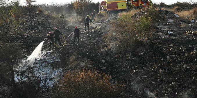 Firefighters battle to put out hot ashes following wildfires near the village of Albas, in the Corbieres Massif mountain range, southern France on 9 August 2025. | BERTRAND GUAY / AFP