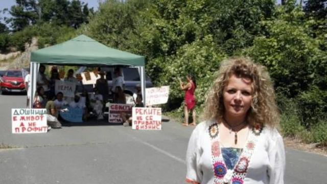 Environmental activist Marina Tomova stands along a road block during a protest against the construction of small hydropower plants on the Dosnica river in Mount Kozuf, near the city of Gevgelija on July 26, 2025.