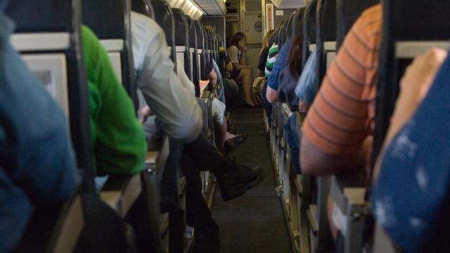 Inside an aeroplane looking down the aisle from the back. | © PAUL J. RICHARDS / AFP/File