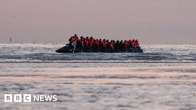 Migrants sit on a dinghy as it prepares to sail into the English Channel on 10 July 2025 in Gravelines, France.