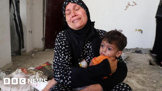 The grandmother of three-year-old Ibrahim al-Mabhuh, who survived an Israeli air strike on a house in Gaza City that killed his parents and two sisters, holds him (3 September 2025)