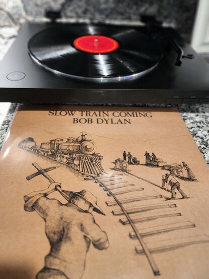 Bob Dylan's Slow Train Coming album in front of a record player