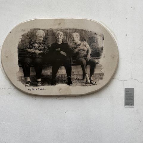 Photo plaque of three women sitting and visiting with each other