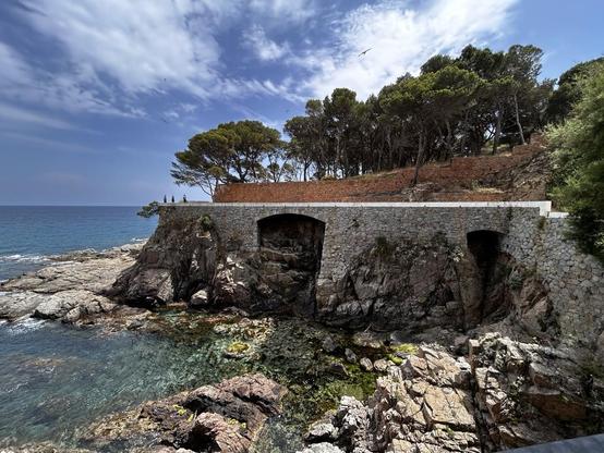 Rocky coastline with structures in the background 