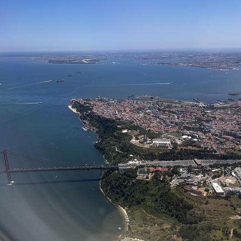 Approaching the city by air. The Tagus River, Almada, and the suspension bridge.