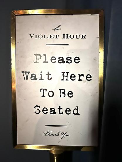 Sign at the entrance: please wait here to be seated. Thank you. 