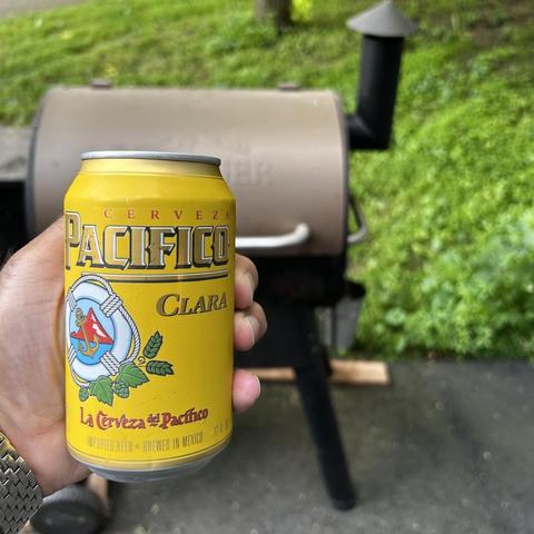Can of Pacifico Clara Cerveza, with a smoker in the background 