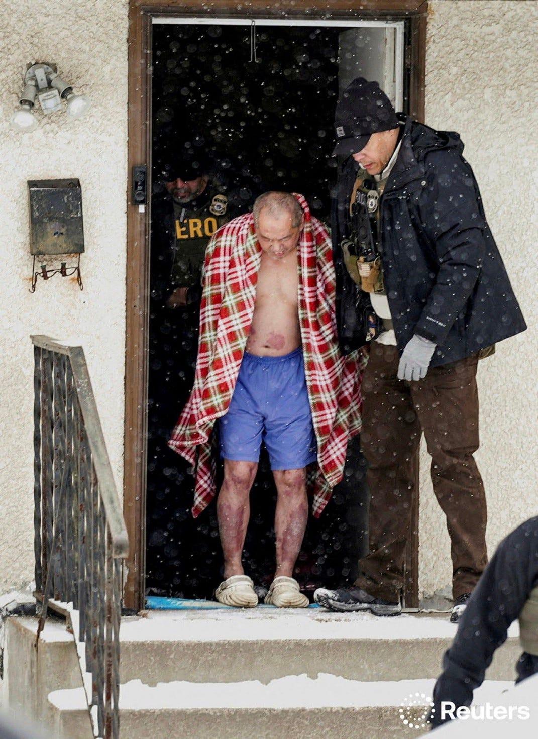 A Reuters photo of Saly, a Hmong citizen of the US, being taken by ICE from his Twin Cities home yesterday, without proper clothing in bitter winter weather