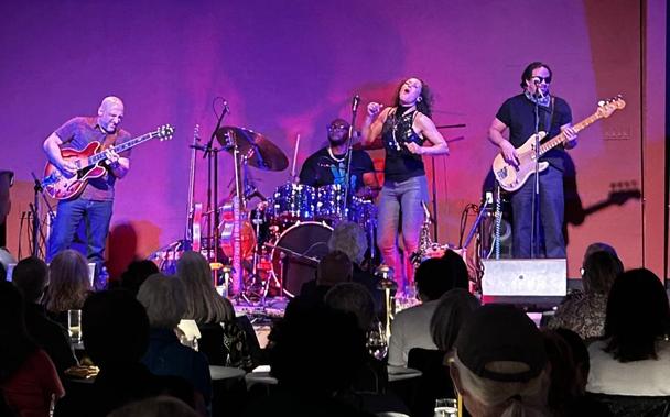 Vanessa singing with her band