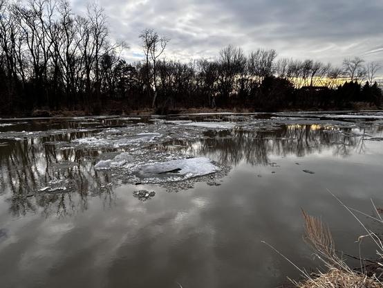 Looking southeastward (toward Minnesota on the opposite bank) over the Red River of the North at Fargo, North Dakota. The ice is mostly melted, but some is still floating downstream (northward toward Canada).