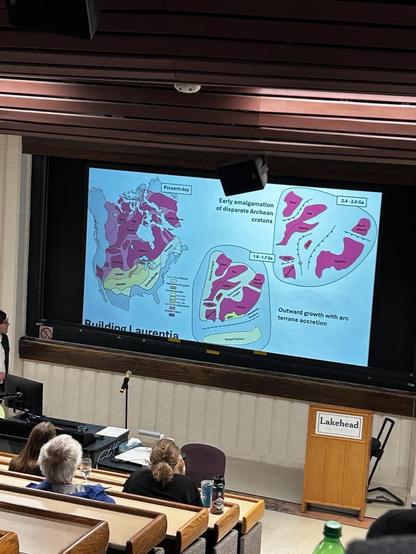 Conference room, with a screen showing Precambrian assembling of North American continental fragments