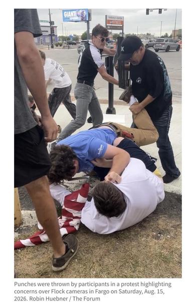 People involved in an altercation.

"Punches were thrown by participants in a protest highlighting concerns over Flock cameras in Fargo on Saturday, Aug. 15, 2026. Robin Huebner / The Forum"