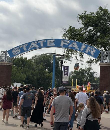 People entering under a large sign: STATE FAIR